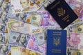 New blue Ukrainian electronic passport of dual citizens and American passpor let Ukrainian hryvna, American dollar bill