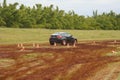 Rear view of a BMW X6 car, black color, smeared with mud.