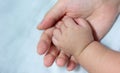 asian baby hand in mother's palm Royalty Free Stock Photo