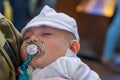 New born baby boy sleeping during his baptism ceremony.