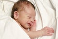 New born baby boy smiling in his sleep. Royalty Free Stock Photo