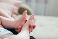 New born baby feet in woman mother hands close up Royalty Free Stock Photo