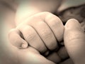 New born baby hand holding mother finger. Royalty Free Stock Photo