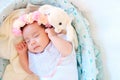 New born baby sleep on the basket or on the bed and keep smile with everyone. Feeling love the new born baby and need to take care Royalty Free Stock Photo