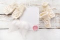 New Born or baptism Greeting Card. Blank with baby girl shoes, gloves and angel wingson white wooden background Royalty Free Stock Photo