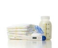 New born child stack of diapers and baby feeding bottle with mil Royalty Free Stock Photo