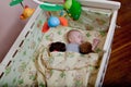 New born child in wooden co-sleeper crib. Infant sleeping in bedside bassinet. Safe co-sleeping in a bed side cot. Little boy taki Royalty Free Stock Photo