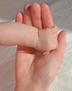 New born clenched baby girl hand holding mothers finger Royalty Free Stock Photo