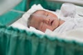 new born infant asleep in the blanket in delivery room Royalty Free Stock Photo