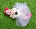 New born Infant child baby girl lying happy smiling on green grass blanket Royalty Free Stock Photo