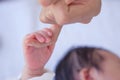 New born little hand holding mum finger in soft tone background