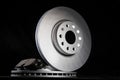 New brake pads and brake discs on a black background. Auto Parts Braking System, close-up Royalty Free Stock Photo