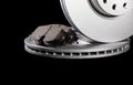 New brake pads and brake discs on a black background. Auto Parts Braking System, close-up Royalty Free Stock Photo