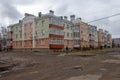 New brick apartment building, old dirt road Royalty Free Stock Photo