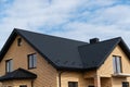 New brick house. The modern house with plastic windows and a black roof of corrugated sheet. Metal roofing Royalty Free Stock Photo