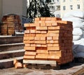 New bricks are stacked on a pallet and bags near the trade pavilion. Royalty Free Stock Photo