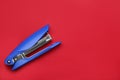 New bright stapler on red background, top view. Space for text Royalty Free Stock Photo