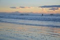 People surfing a New brighton beach during sunrise time. Royalty Free Stock Photo