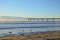 People surfing a New brighton beach during sunrise time. Royalty Free Stock Photo