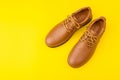 New brown men leather shoes. Studio shot isolated on yellow Royalty Free Stock Photo