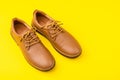 New brown men leather shoes. Studio shot isolated on yellow Royalty Free Stock Photo