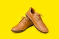 New brown men leather shoes. Studio shot isolated on yellow Royalty Free Stock Photo