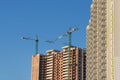 New building construction background clear blue sky. Multistory house. Mortgage. Tower cranes construction site building Royalty Free Stock Photo