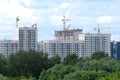 New building construction in new district after river over sky with white clouds in summer day Royalty Free Stock Photo