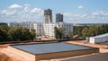 New building construction site with a large flat-roofed structure under construction, surrounded by recently built apartment Royalty Free Stock Photo
