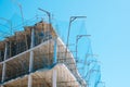 New building with safety net on construction site over blue sky background. Construction of modern apartment house, new Royalty Free Stock Photo