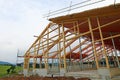 The new building of a timber house with roof framework