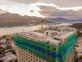 New buildings being constructed. Industrial building site. Shot of lifting crane and skyscraper under construction Royalty Free Stock Photo