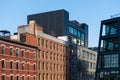 Old brick buildings contrasted with modern glass and steel architecture