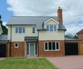 New builds, empty, detached family house. Brick & weatherboard. Royalty Free Stock Photo