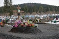 New burial with artificial flowers, on an old village cemetery. Royalty Free Stock Photo