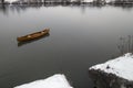 New Canoe floating on the calm water in winter sunset