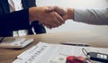 New car buyers and car salesmen are shaking hands to make agreements about car sales