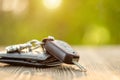 New car keys with black leather wallet on wooden table. Car purchase or car rental concept Royalty Free Stock Photo