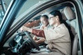 Woman with long dark hair sitting behind the wheel of her new car