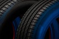 New car tires. Group of road wheels on dark background. Summer Tires with asymmetric tread design Royalty Free Stock Photo