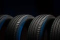 New car tires. Group of road wheels on dark background. Summer Tires with asymmetric tread design Royalty Free Stock Photo