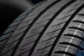 New car tires. Group of road wheels on dark background. Summer Tires with asymmetric tread design Royalty Free Stock Photo