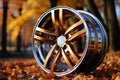 new car wheel, alloy rim in autumn forest with bright yellow leaves Royalty Free Stock Photo