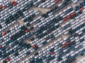 New cars are standing in straight diagonal rows in the parking lot, aerial view Royalty Free Stock Photo