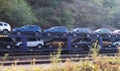 New cars transported with railway platforms. Cars transported by rail. The cars are Dacia Duster of several colors. Many cars