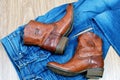 Brown cowboy boots on blue jeans Royalty Free Stock Photo