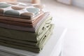 New clean folded bed linens on table indoors. Space for text Royalty Free Stock Photo