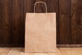 Paper Shopping Brown Bag On Brown Rustic Background. Royalty Free Stock Photo