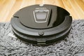 New Clean Robot vacuum cleaner on laminate wood floor.