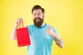 New collection. happy hipster hold paperbag. Man with gift package. Buy product. little pleasantness. bearded man go